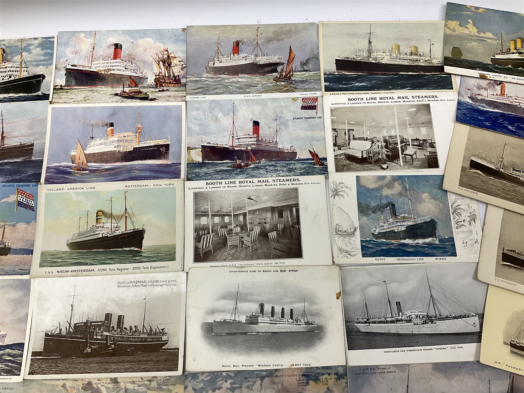 Sixty-five early 20th century postcards of passenger liners including White Star, Red Star, Atlantic Transport, Anchor, Cunard, Henderson, Booth, Union Castle, Holland America, Lamport & Holt, P. & O., New Zealand, Canadian Pacific, British India etc; and ten Edwardian postcards of Naval warships and officers (75)