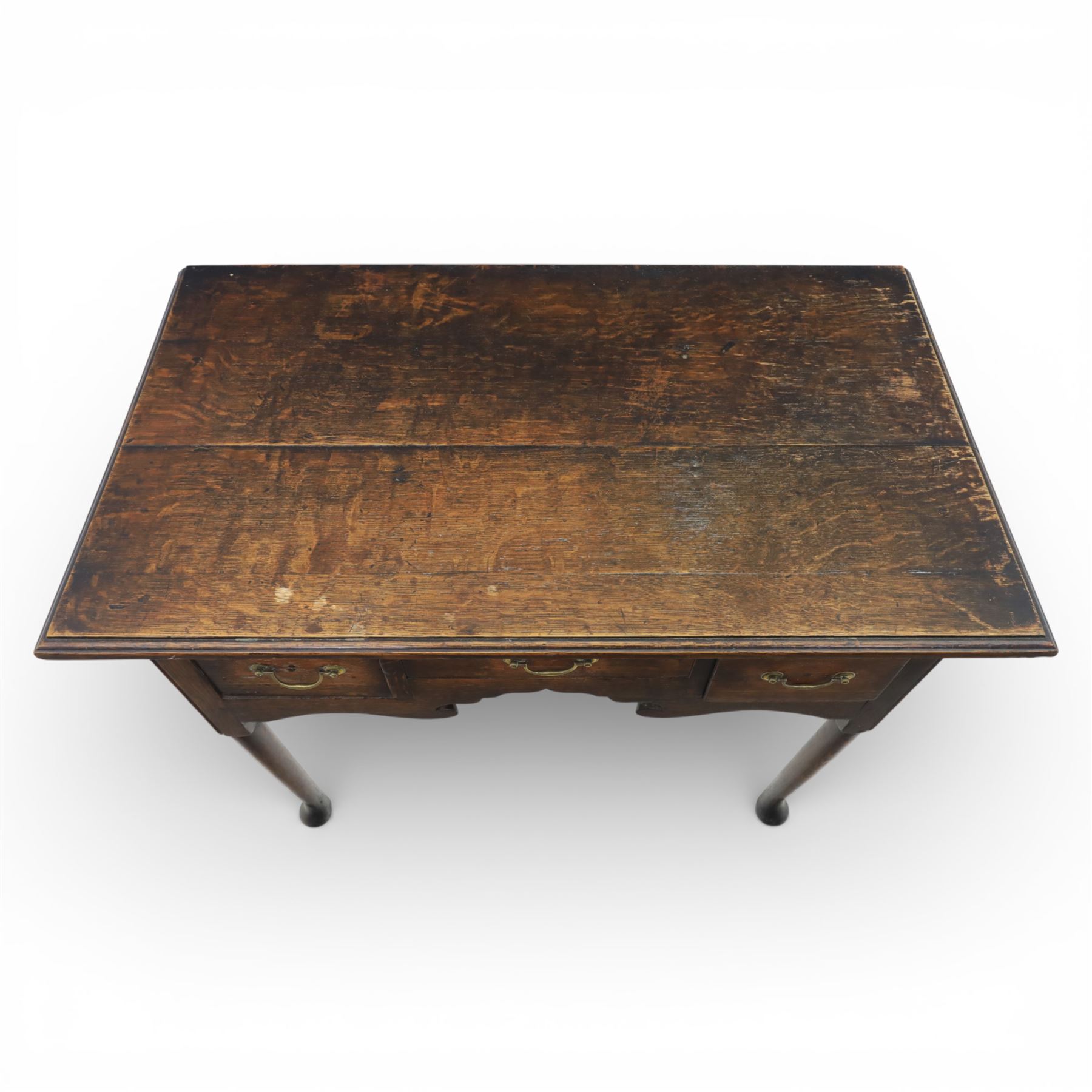 Georgian oak lowboy, the rectangular top with moulded edge over three fitted drawers and shaped apron, raised upon slender cabriole legs, with pad feet