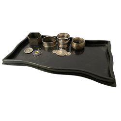 Four hallmarked silver napkin rings (total weight 83g) ebonised tray with hallmarked silver plaque with foliate engraving and two hallmarked silver pendants including an enamel Huddersfield Schools example 