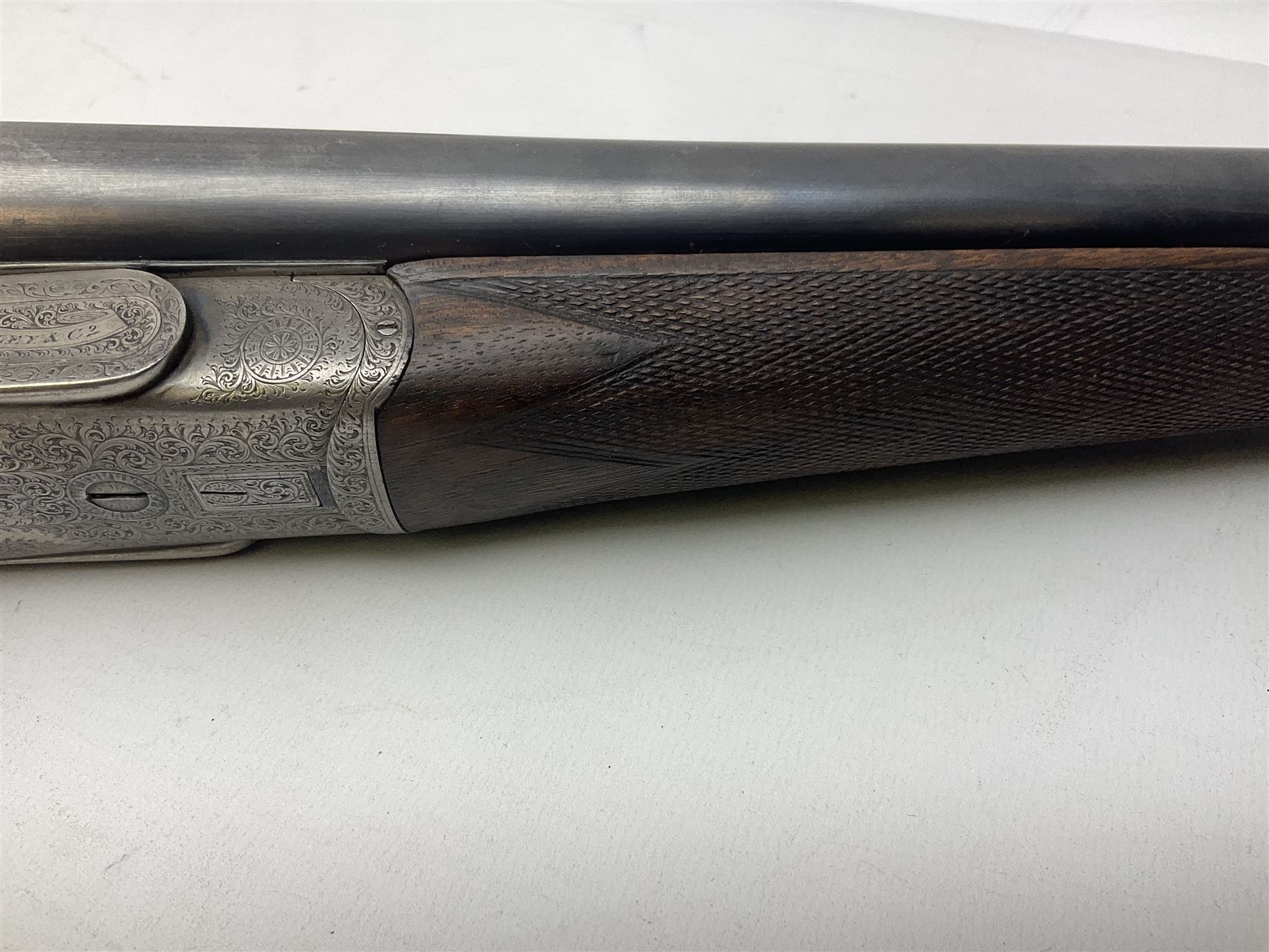 Smith Midgley Bradford 12-bore side-by-side double barrel side-lock ejector shotgun with 71cm barrels, engraved action with patented top lever, ivy leaf fences and top safety, walnut stock with chequered grip and fore-end, serial no.62409 to barrels and 1481 to action, L115cm overall SHOTGUN CERTIFICATE REQUIRED