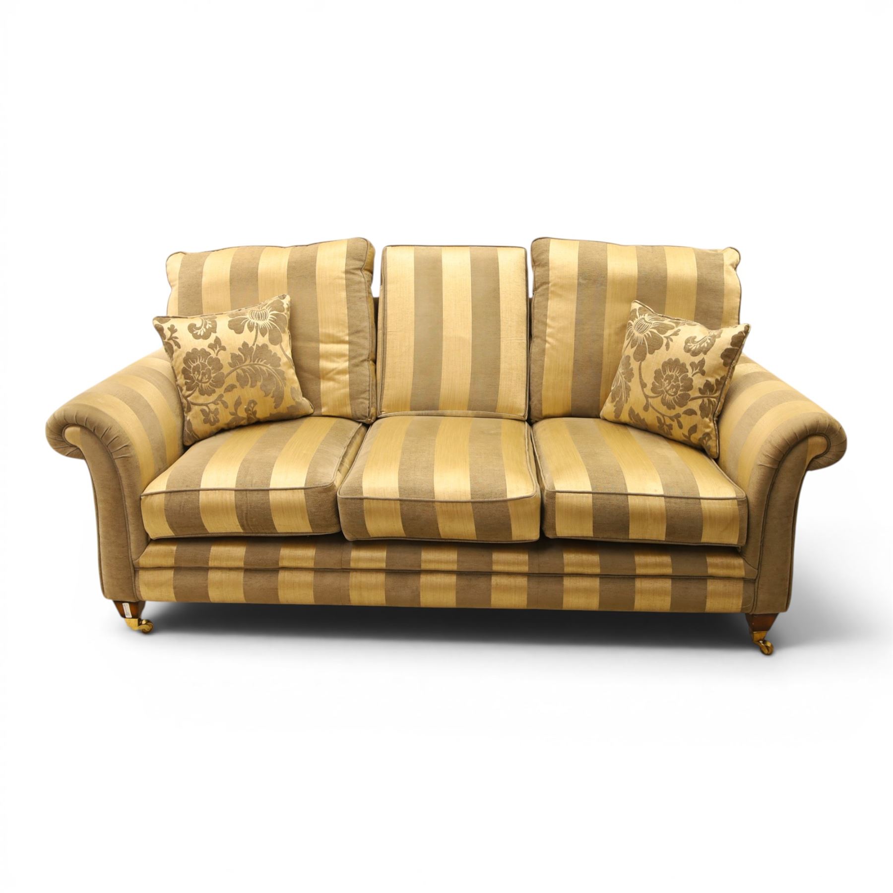 Alstons - 'Ixworth' three seat sofa, upholstered in striped fabric, with loose seat cushions and scrolled arms, front brass castors
