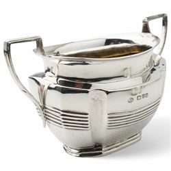 Late Victorian silver three piece tea set of panel sided oval design, the teapot with ebonised handle and lift, Chester 1898/99 Maker Florence Warden and William Aitken