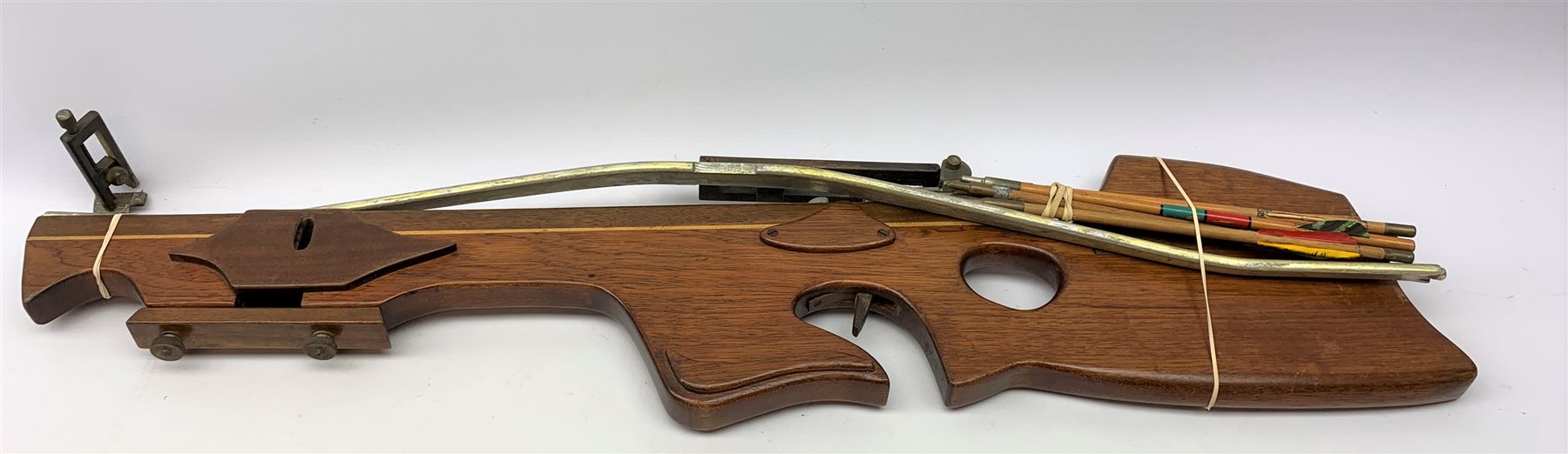20th century crossbow with sectional mahogany shaped stock and Nikko Stirling telescopic sight L89cm; together with another similar with hinged foresight; and six arrows (8)