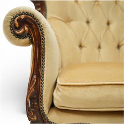 Late 19th century style carved hardwood armchair, the openwork crest rail with scrolling and foliate ornament, upholstered back and outscrolled arms with buttoning, loose seat cushion, nailhead trim, on carved cabriole legs