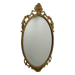 Giltwood oval wall mirror with carved Rococo-style frame, scrolling acanthus leaves and pierced crest (H71cm); smaller oval mirror with floral pattern and openwork scrolls, surmounted by a rose crest (H54cm)