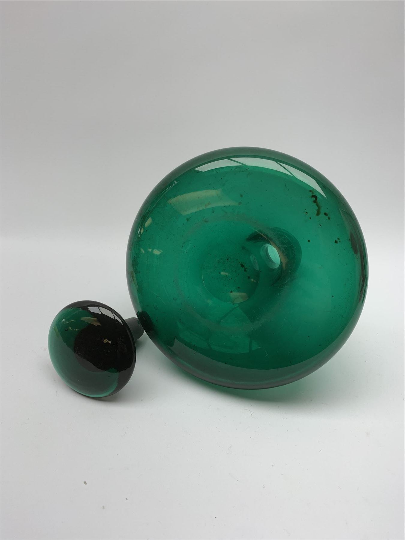 19th century green glass ships decanter with flat topped stopper, H21.5cm, together with a set of four 19th century green glass wine glasses, the funnel bowls upon bladed knopped stems and circular feet, H13cm