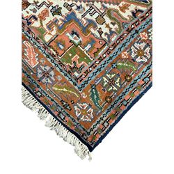 Persian Heriz indigo and rust ground rug, central geometric star medallion decorated with stylised foliate motifs, the border decorated with stylised flower heads