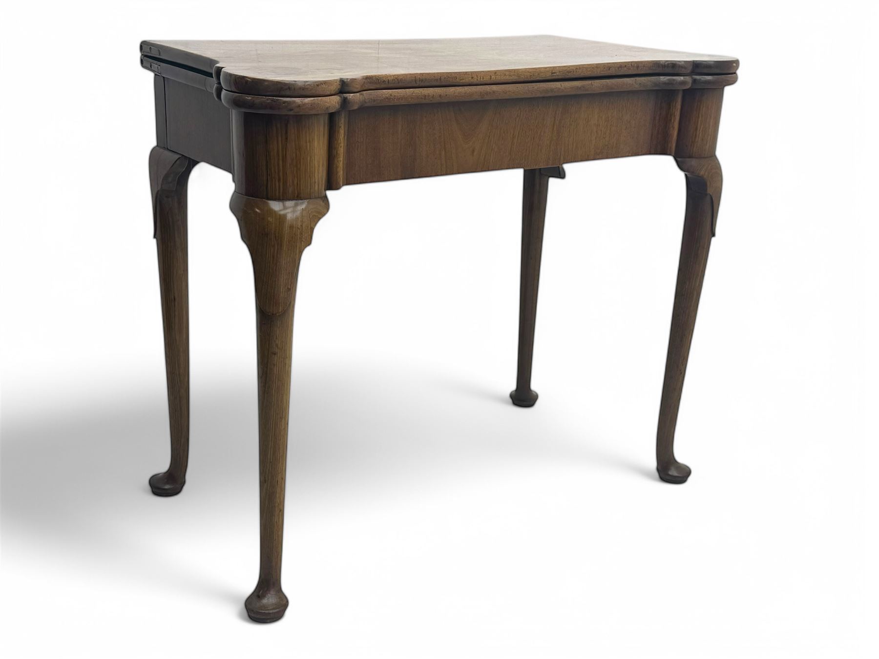 George III mahogany fold-top card table, shaped rectangular top opening to reveal a baize-lined surface, supported by a concertina pull-out concertina rear mechanism, raised on cabriole supports with foliate carvings terminating in pad feet