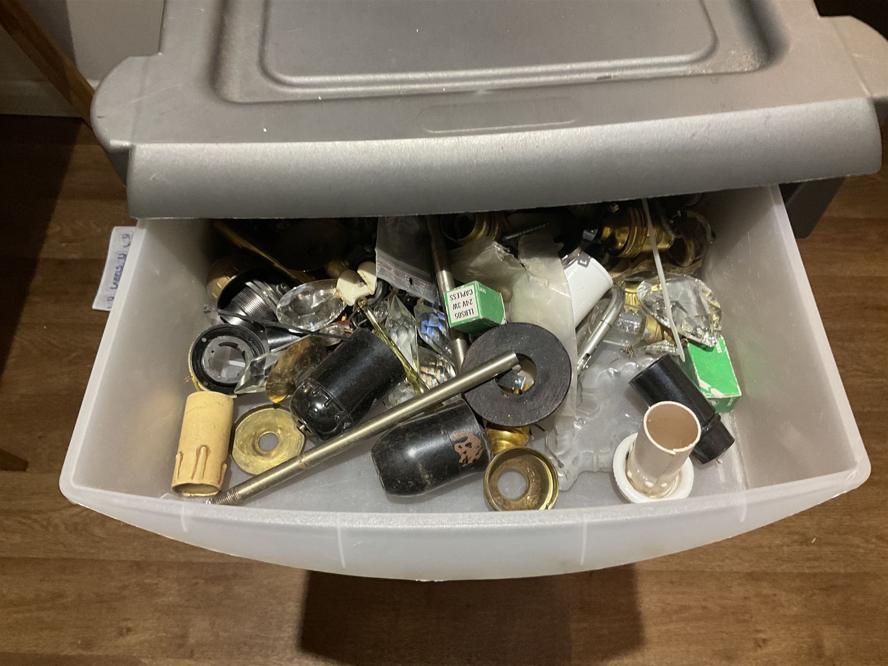 Large quantity of light fitting spare parts and accessories in plastic floor standing six-drawer chest
