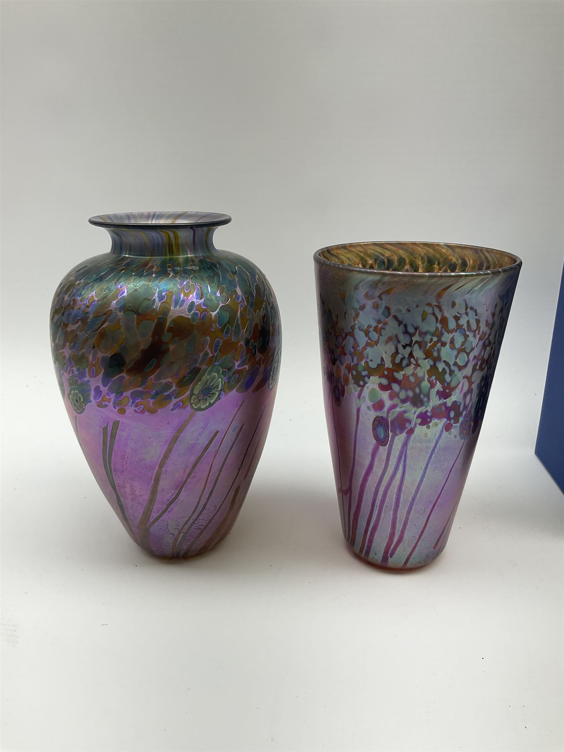 Two Art Glass Jonathan Harris vases, The first example of a baluster form, the second example of tapering cylindrical form,  each with iridescent decoration in tones of purple and blue, tallest example H18.5cm, each with makers box, together with a Isle of Wight glass paperweight. 