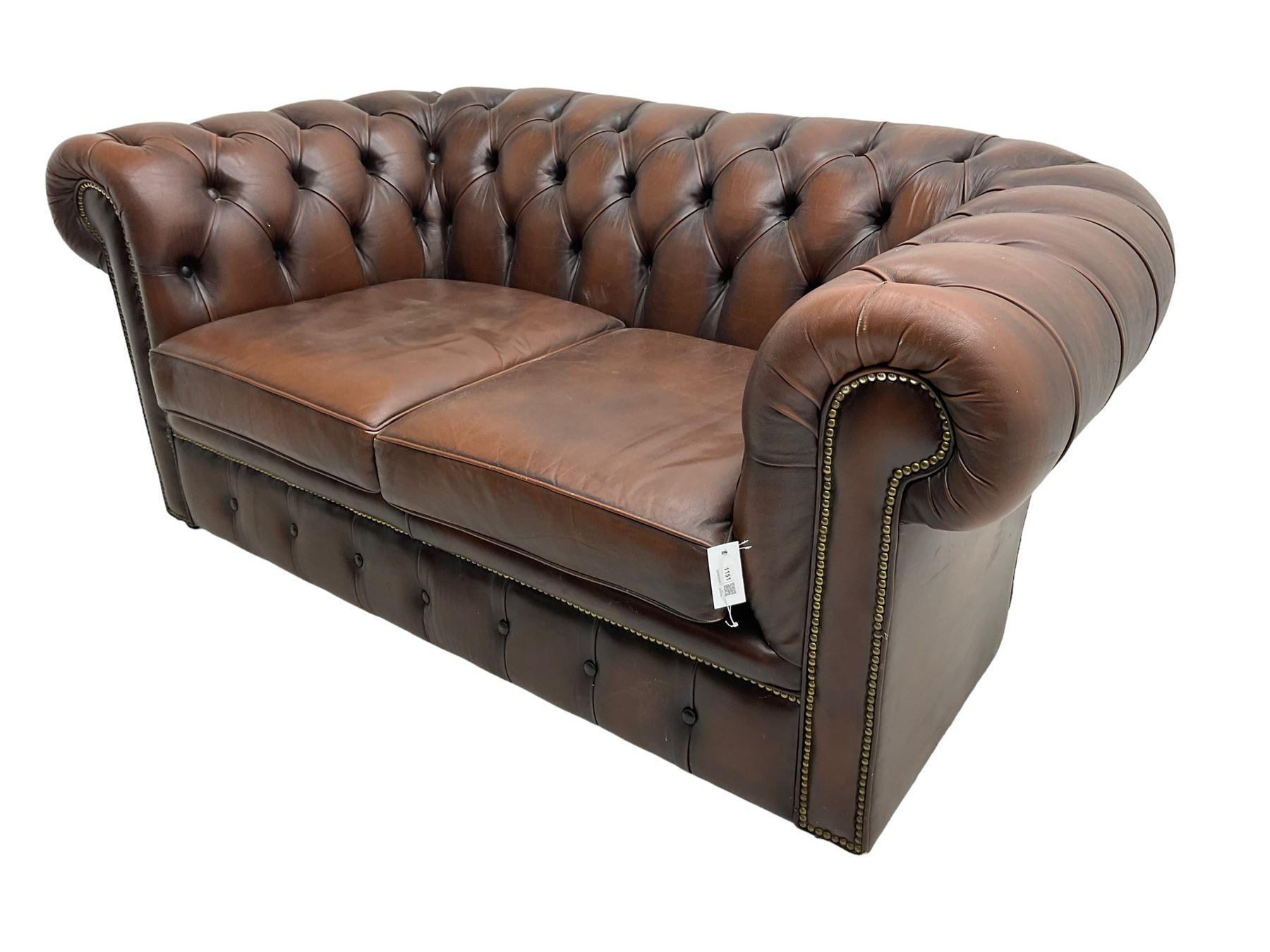 Chesterfield two seat sofa, upholstered in brown buttoned leather