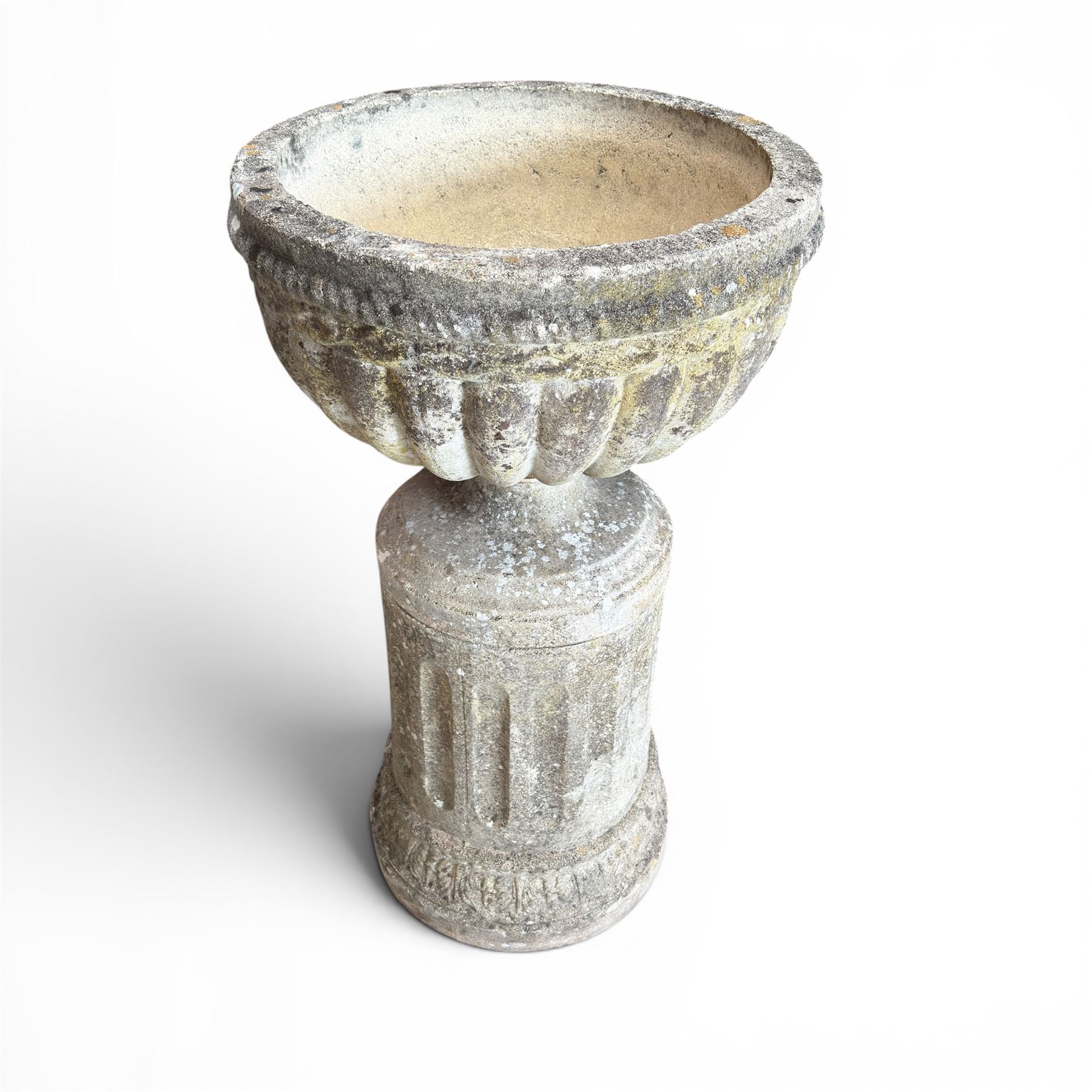 20th century good quality weathered cast stone pedestal urn of ecclesiastical design, circular lobed bowl with rope twist and lattice border, raised on squat base with fluted column  and acanthus decorated base
