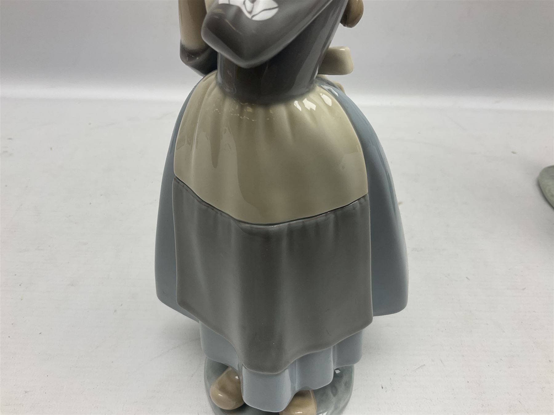 Three Lladro figures, comprising Dutch Girl with Braids no 5063, Dutch Girl with Duck no 5066 and Aracely with Ducks, all with original boxes, largest example H25cm