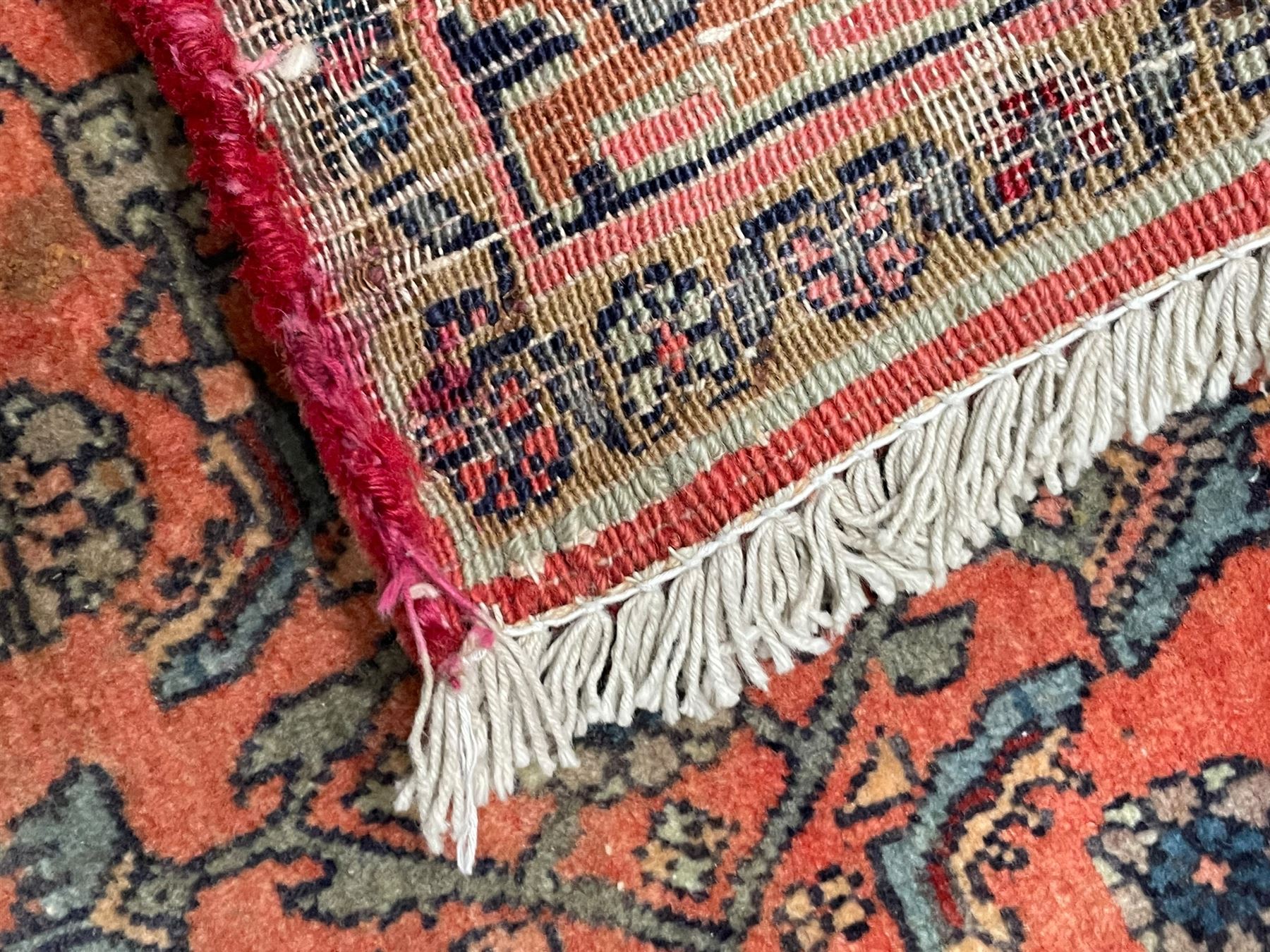 Persian Zanjan pale red ground rug, lozenge medallion and field decorated with floral Herati motifs, the border decorated with stylised plant motifs and trailing branches, floral pattern guard stripes