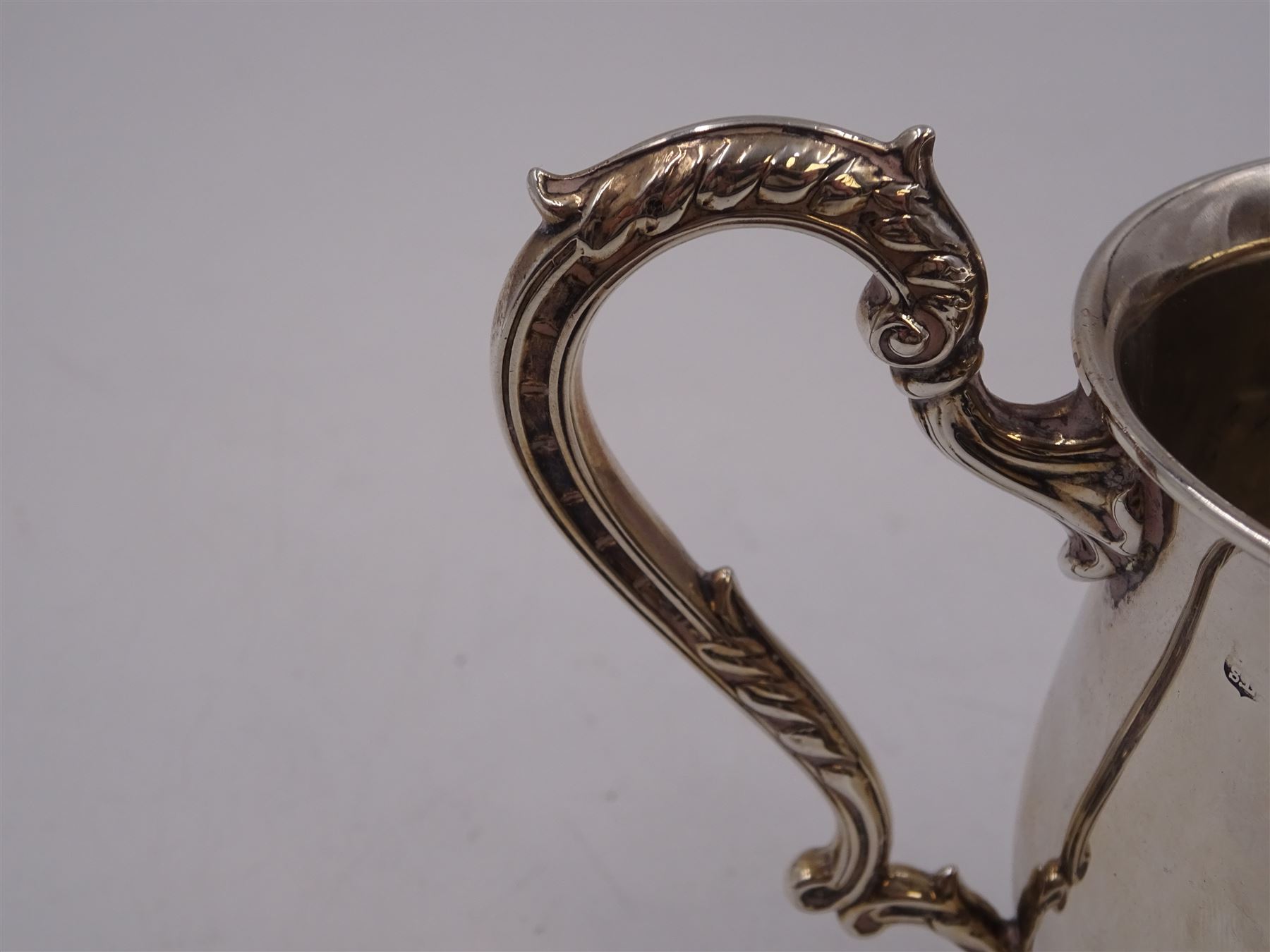 1930s silver Christening mug, of plain waisted form, with acanthus capped scroll handle, upon stepped circular foot, hallmarked Barker Brothers Silver Ltd, Birmingham 1933, including handle H10cm 