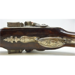  Pair of mid 18th century French flintlock 26 bore side-by-side double barrel holster pistols by Mercier a Paris, 24cm tapering sighted barrels, engraved hammer and lock-plate, full walnut stock with carved detail, the silver trigger guard with urn finial and butt cap cast with the head of a Sun God, the silver crowned cartouche engraved with a crest and flanked by birds and with silver wire tendrils, with wood ramrod in silver pipes 42cm overall  