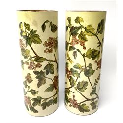A pair of 19th century Doulton Lambeth vases, of cylindrical form hand painted with butterflies amongst blossoming branches, with impressed marks beneath and dated 1875, H26.5cm. 