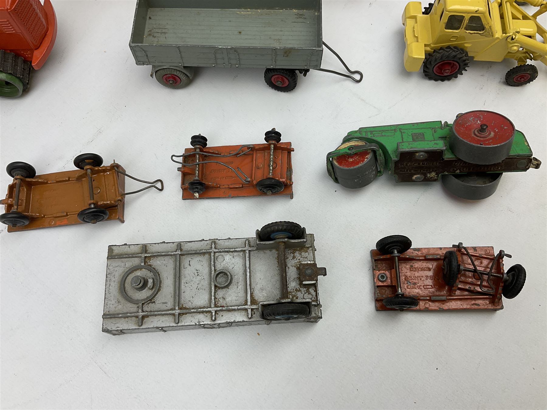 Dinky - nineteen unboxed and playworn/repainted die-cast models including Muir Hill Dumper, Muir Hill 2WL and Heavy Tractor; all repainted; Coles Mobile Crane, two Aveling-Barford steam rollers; Massey-Harris tractor and manure spreader; Land Rover; nine various trailers etc (19)