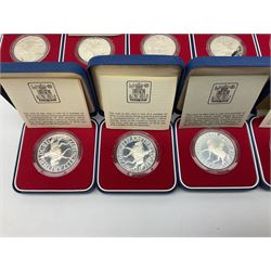 Eighteen Queen Elizabeth II 1977 silver proof crown coins, all cased with certificates (18)