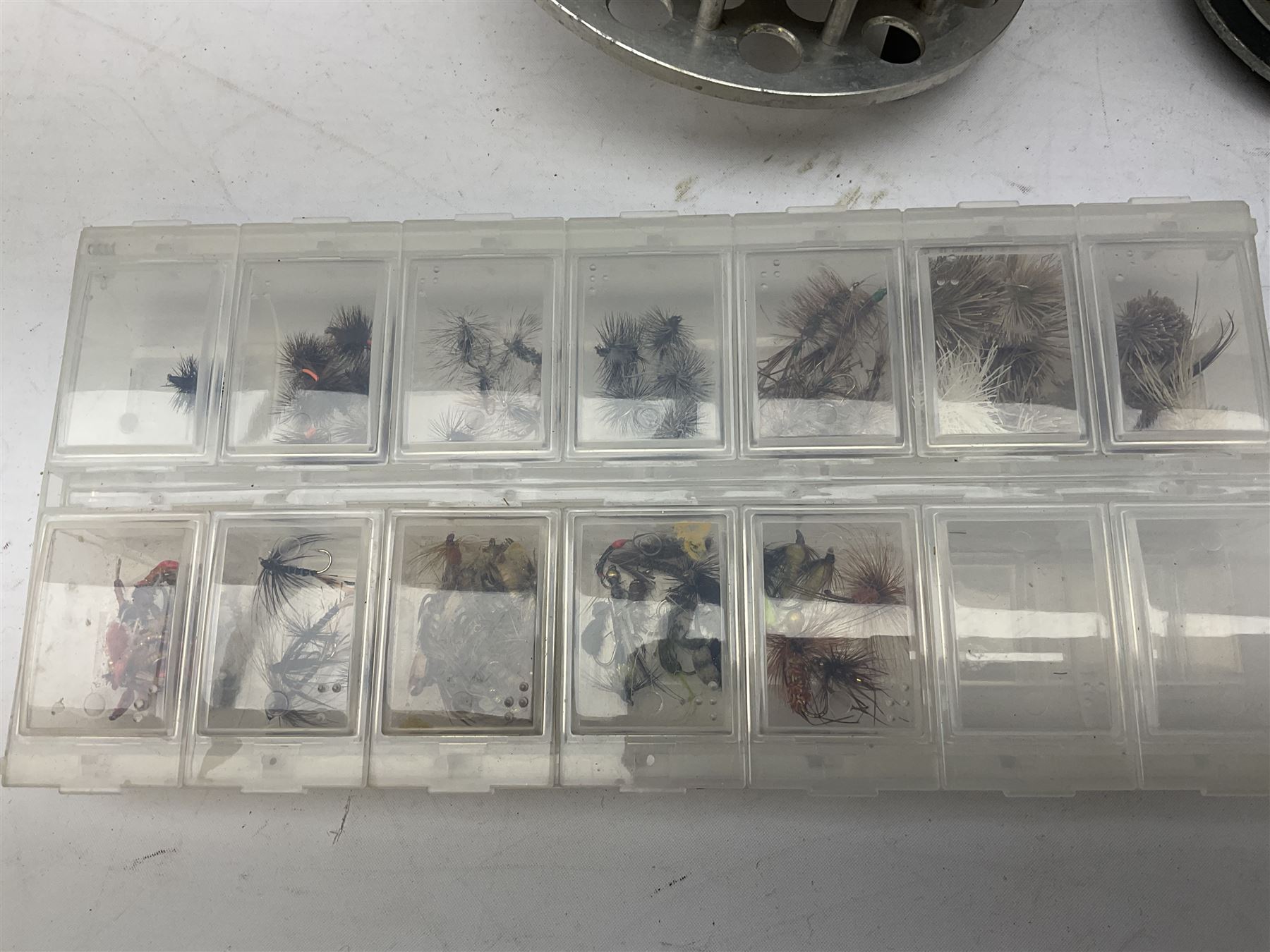 Fishing tackle, including 'The Gnat' fly reel, Alvey 4 1/2 inch reel, Paramount 4 1/2 inch reel, other fishing reels, various fishing flies and other similar items in a carry bag 