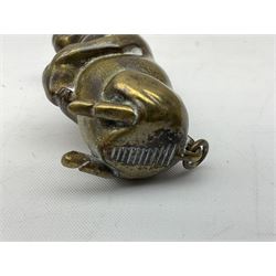 Victorian novelty brass vesta case modelled in the form of a pig holding a money bag, together with a silver vesta, hallmarked 