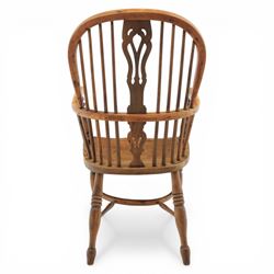 Early 20th century yew wood Windsor armchair, hooped back with spindle supports and shaped pierced central splat, solid seat with shaped edge, turned arm supports, on turned legs united by crinoline stretcher