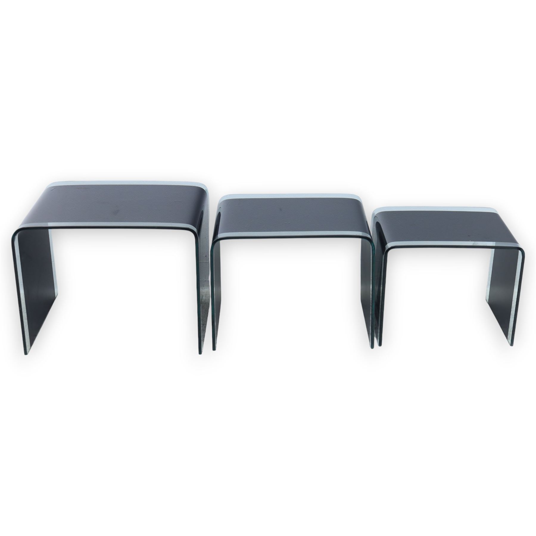 Nest of three contemporary glass occasional tables, black glass centres with  clear glass borders 