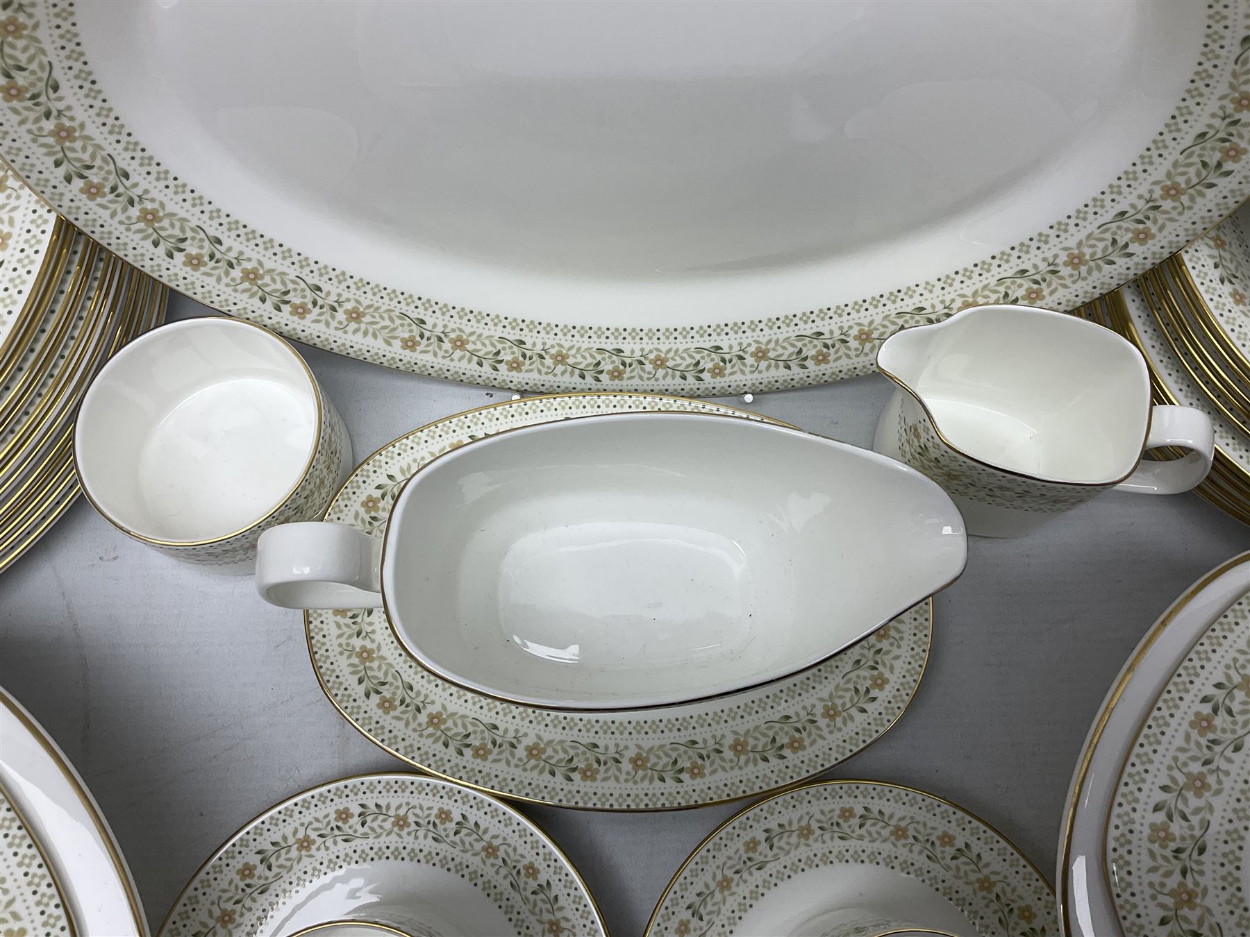 Royal Doulton Paisley pattern tea and dinner service for twelve, comprising dinner plates, side plates, soup bowls, dessert bowls, tea plates, two lidded tureens, sauce boat and saucer, sucrier and jug, oval serving dish and teacups and saucers