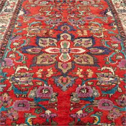 North West Persian Mahal hand-knotted runner, deep red ground, with a vertical arrangement of angular floral and geometric motifs, enclosed by an ivory border  of stylized leaves and rosettes, with guard stripes on indigo ground, cotton fringe ends 