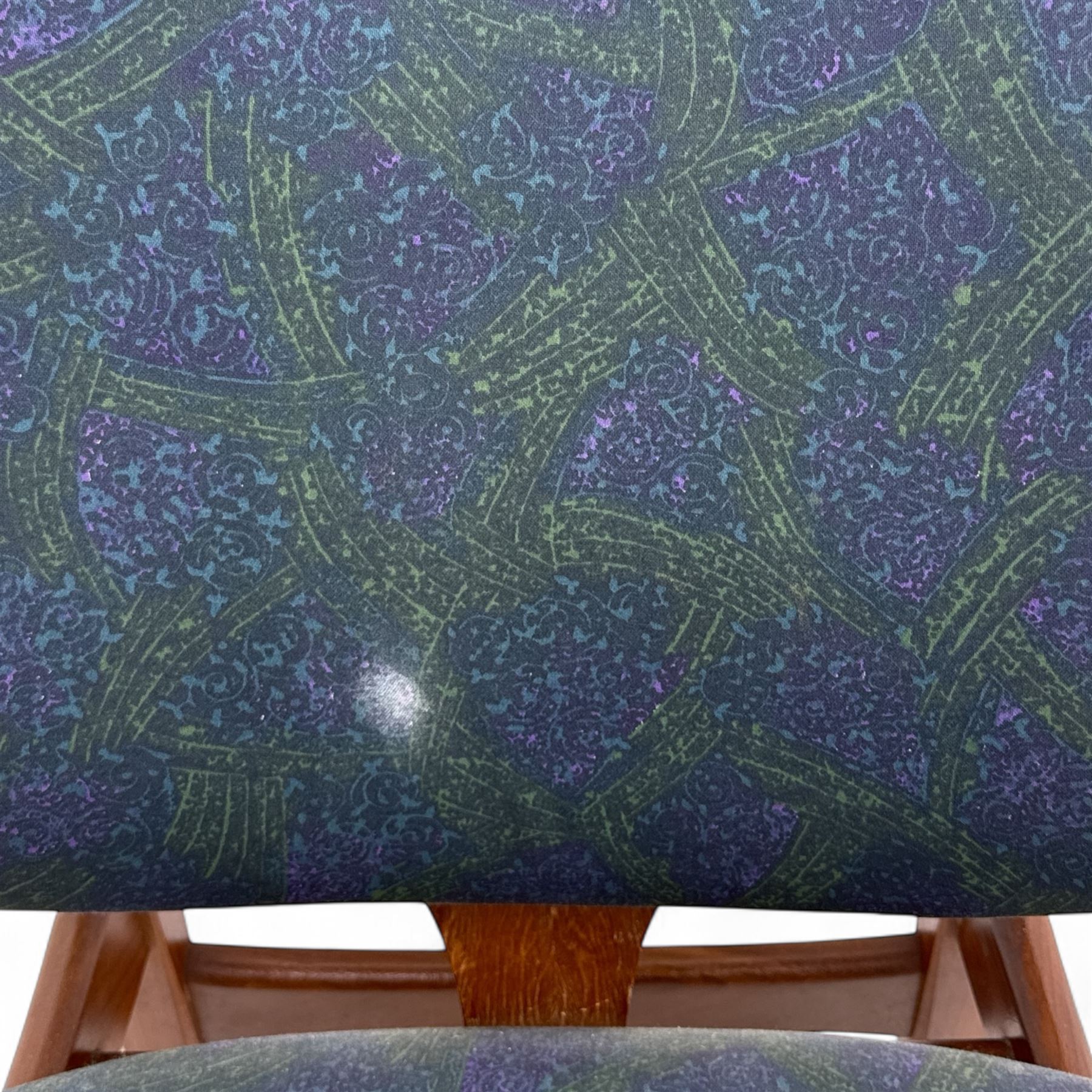 G-Plan - mid-20th century teak oval dining table, with butterfly leaf extension mechanism and four Elliot's of Newbury teak framed dining chairs upholstered in purple and green fabric, table un-extended width 152cm x depth 152cm x height 71cm, chairs 47x37x78cm 