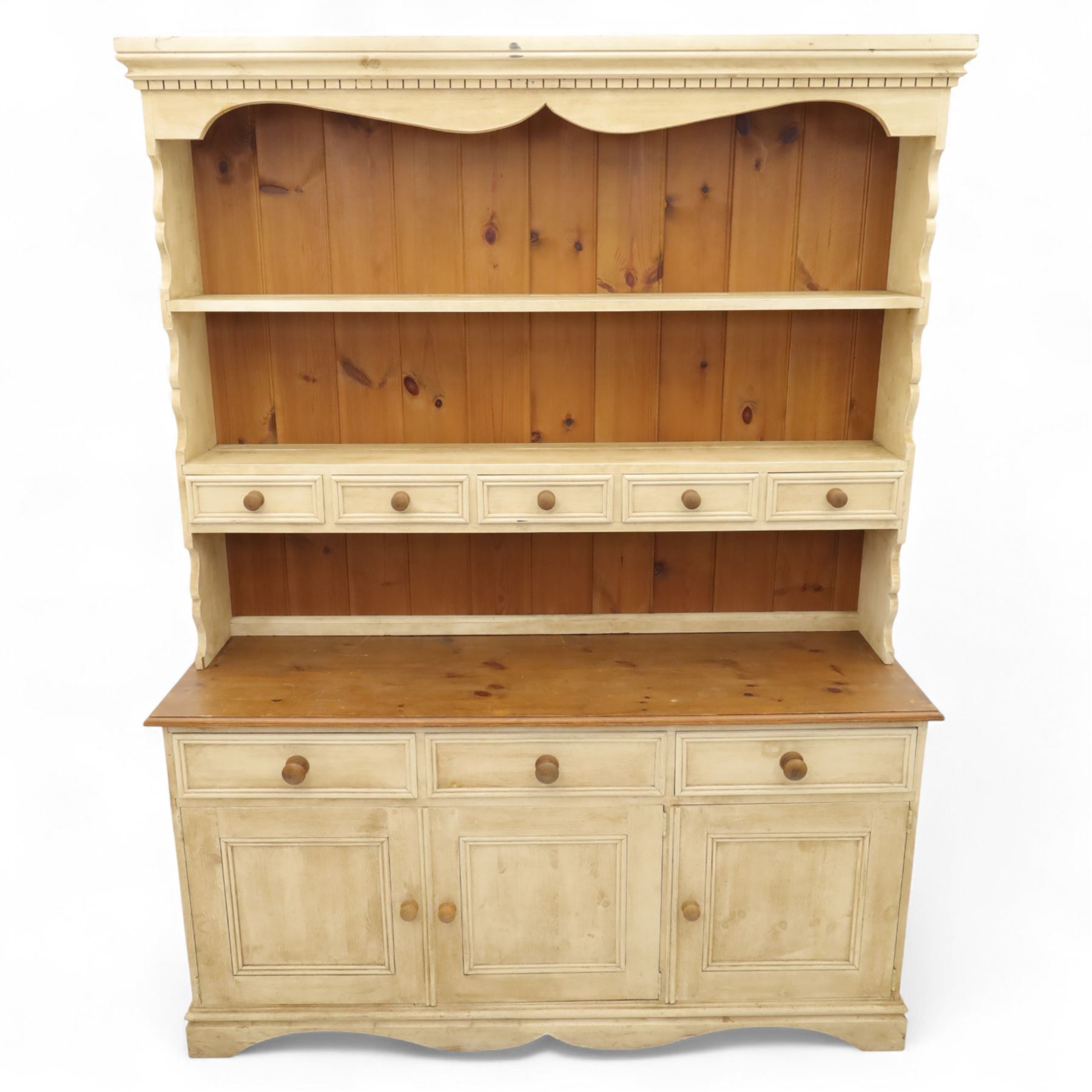 20th century painted pine dresser, moulded cornice above shaped frieze and two open plate shelves, central row of five small drawers with wooden knobs, base fitted with three drawers over a pair of panelled cupboard doors, on shaped plinth base