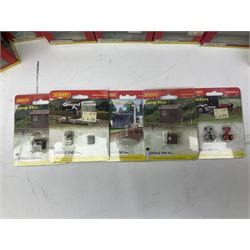 Hornby 'N' gauge - eighteen Lyddle End trackside buildings including The Old Toll House, Electricity Sub Station, Teesdale bakery, Mason's Arms Pub, various shops and hairdressers, farm buildings, Clock Tower etc; all boxed; and five Lyddle End blister pack cards of trackside accessories including Lamp Huts, Tractors, War memorial etc (23)