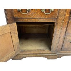 George III oak dresser, projecting dentil cornice over three heights plate rack enclosed by fluted uprights, the dresser fitted with five drawers and two panelled cupboards, canted corners with fluted quarter columns, on bracket feet