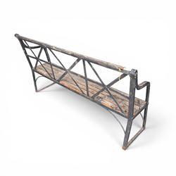 19th century and later Estate made wrought iron strapwork garden bench, the weathered wooden cresting rail over X-form strapwork back and slatted wooden seat
