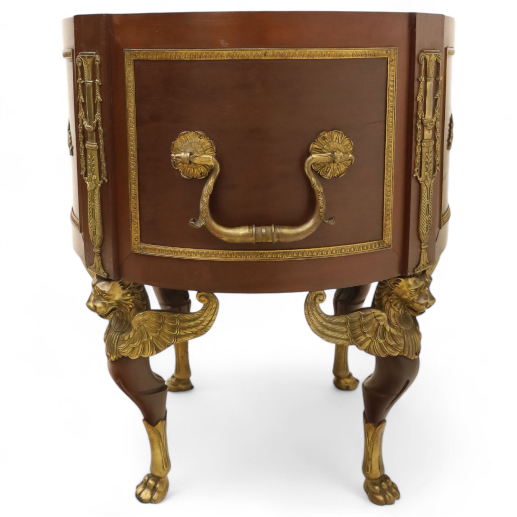 An imposing and richly adorned Empire Revival jardiniere of circular form, decorated with finely cast gilt bronze laurel garlands and floral swags, interior with a modern brass liner, sides with gilt bronze carrying handles, raised on three tripod legs with classical caryatid masks with wings terminating in lion paw feet, circa 1900

Provenance: This jardiniere formed part of the original furnishings of the opulent Empire Room at Kinloch Castle, built by industrialist George Bullough in 1900.

An original inventory number, ‘X954’, is inscribed on one facing, verifying its presence in the Kinloch Castle collection. This jardiniere epitomises the lavish taste of the Edwardian elite and the high standards of craftsmanship employed in the furnishing of Kinloch Castle, the first private home in Scotland to be lit by electricity and famed for its extravagant interiors.


