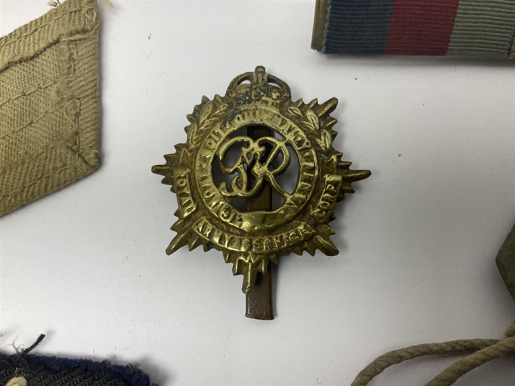 WWII group of three medals comprising 1939-45 War Medal and Italy and Africa Stars in issue box; dog tags for 282894 W. Wilkinson with framed photograph in uniform; and small quantity of cloth and metal badges including RAOC cap badge