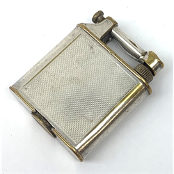 A Dunhill silver plated cigarette lighter, with engine turned panels to the body, marked to arm Dunhill Reg No 737418, marked beneath Pat No 390107 Made in England, H5cm. 