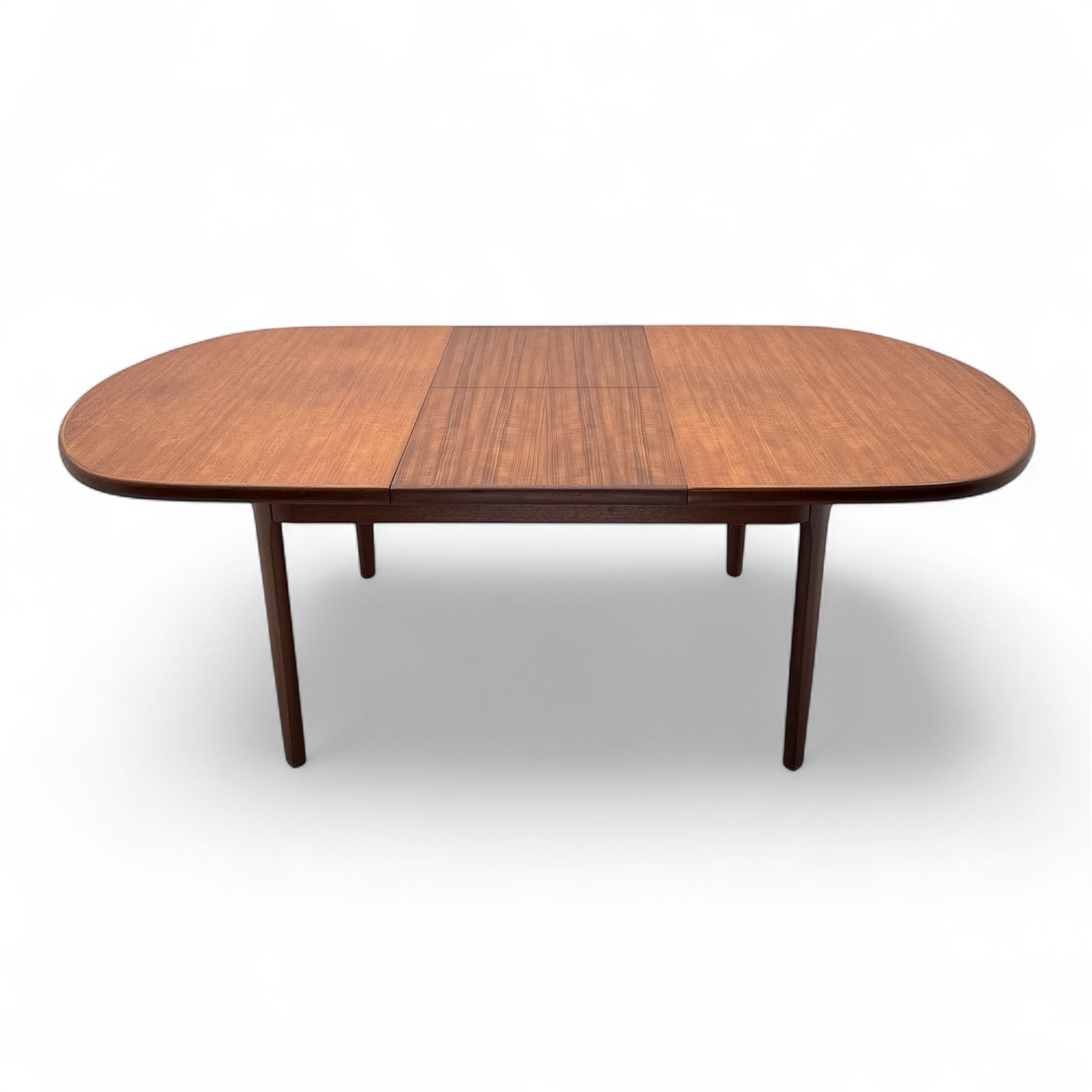 G-Plan - mid-20th century teak oval dining table, with butterfly leaf extension mechanism and four Elliot's of Newbury teak framed dining chairs upholstered in purple and green fabric, table un-extended width 152cm x depth 152cm x height 71cm, chairs 47x37x78cm 