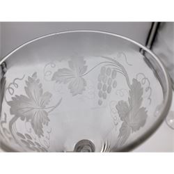 Set of three 18th century style wine glasses, each with funnel bowl etched with fruit vine, upon a double series air twist stem and circular foot, H17cm