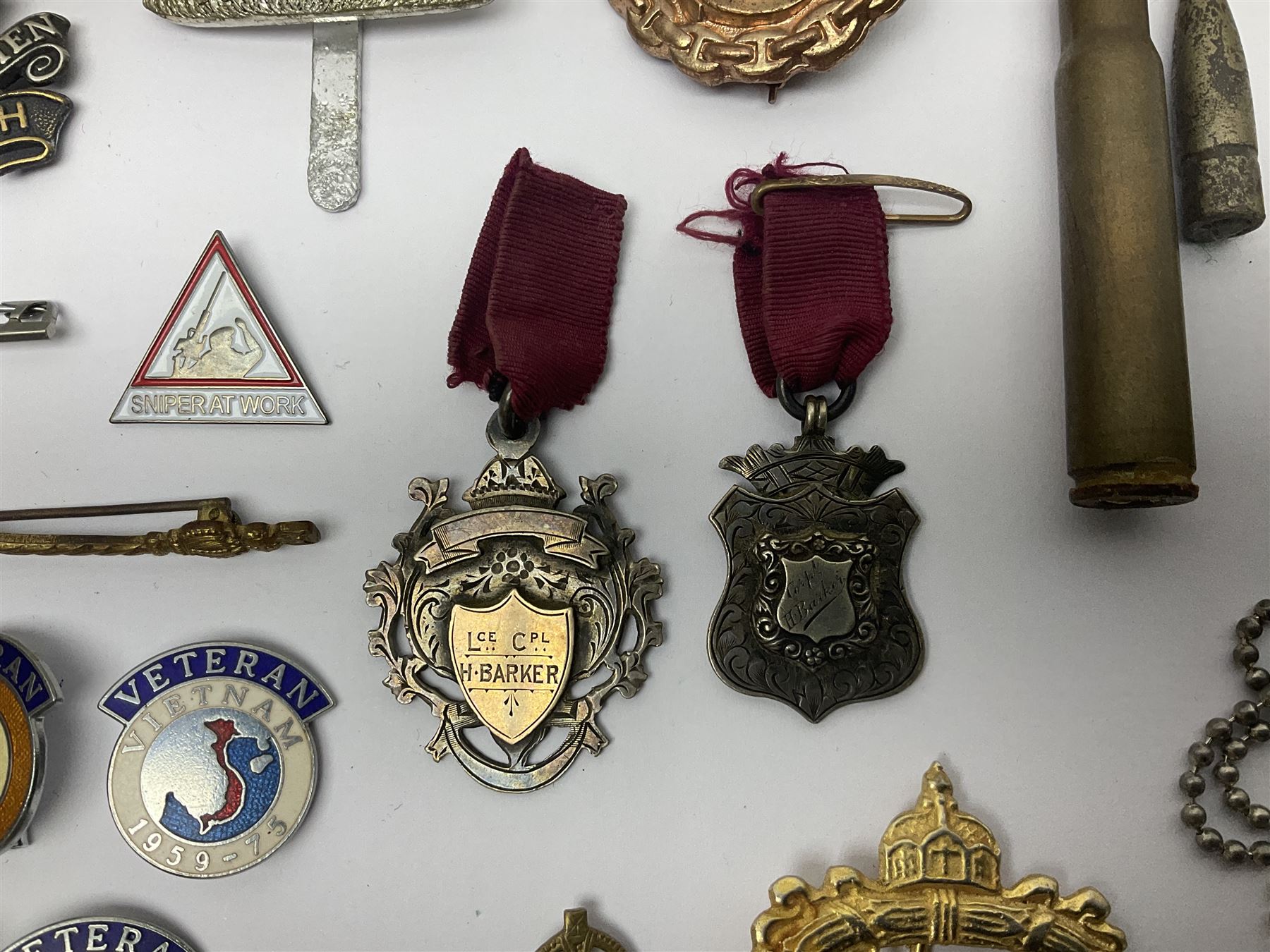 Two Edwardian hallmarked silver presentation fobs for military bugling competitions; and quantity of cap/glengarry and other badges, sweetheart brooches etc