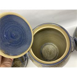 John Egerton (c1945-): set of five studio pottery stoneware twin handled jars with covers, decorated with blue birds upon a brown mottled ground, H20cm