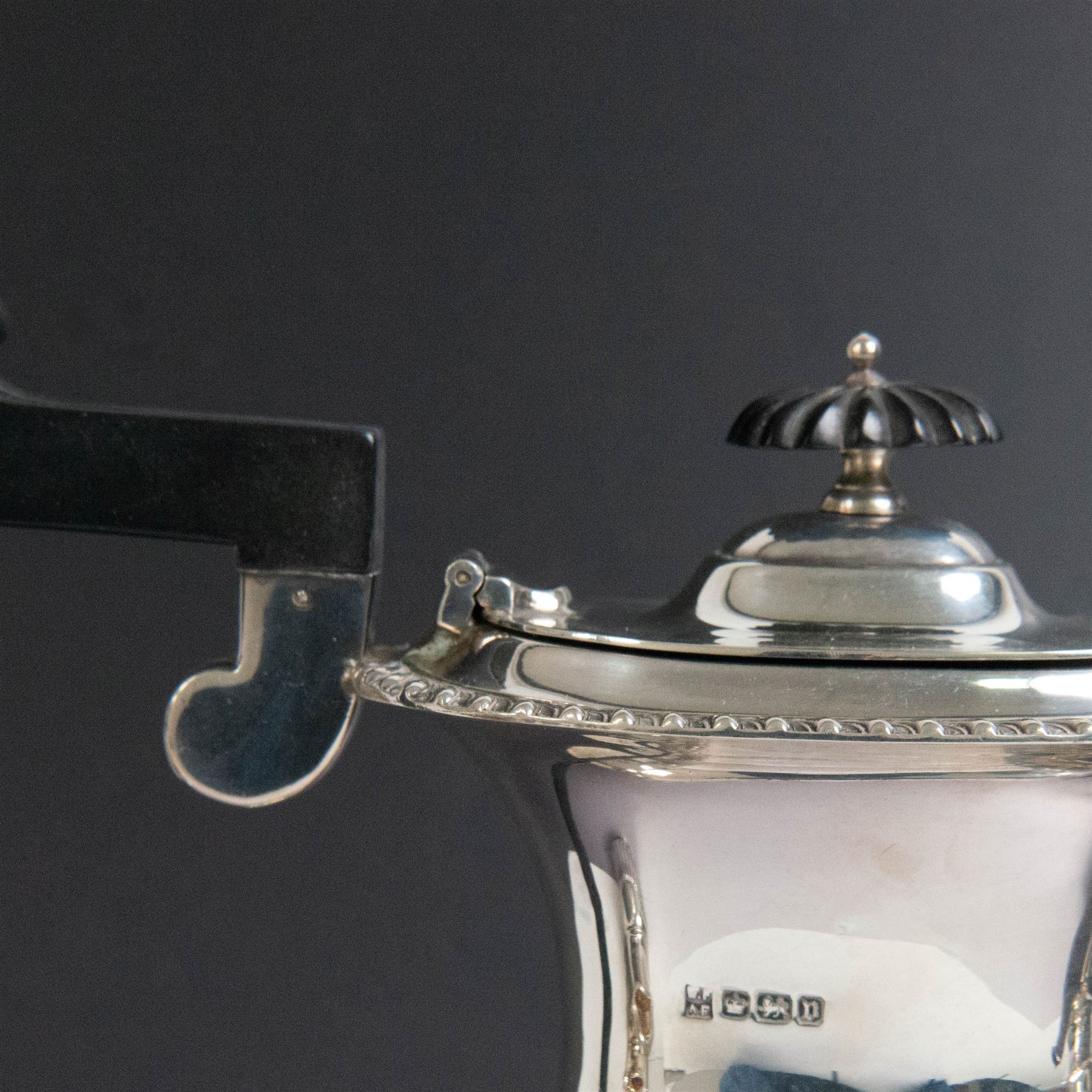 Edwardian silver four piece tea service, comprising coffee pot, teapot, twin handled open sucrier and milk jug, all of oval bellied form, part fluted and with oblique gadrooned rim, with Bakelite type handles and finials to teapot and coffee pot, hallmarked Fordham & Faulkner, Sheffield 1913