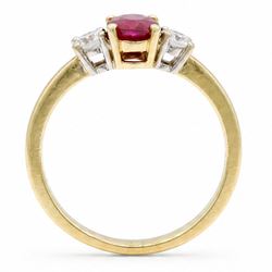 18ct gold ruby and diamond three stone ring, single oval cut ruby of 1.06 carat, with a round brilliant cut diamond set either side, hallmarked, total diamond weight 0.31 carat