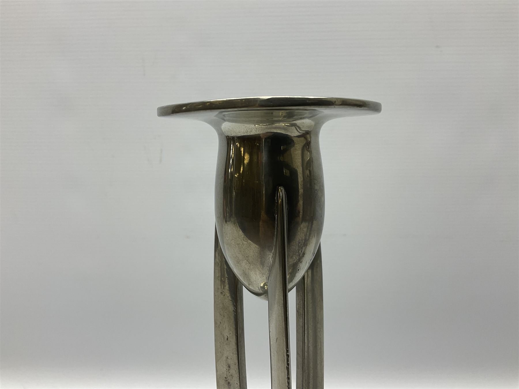 Archibald Knox (1864-1933) for Liberty & Co, pair of Tudric pewter candlesticks, the bud shaped sockets raised upon three angular fin supports and a slightly domed circular base with cast stylised foliate decoration, each stamped beneath Tudric 0223, H30cm