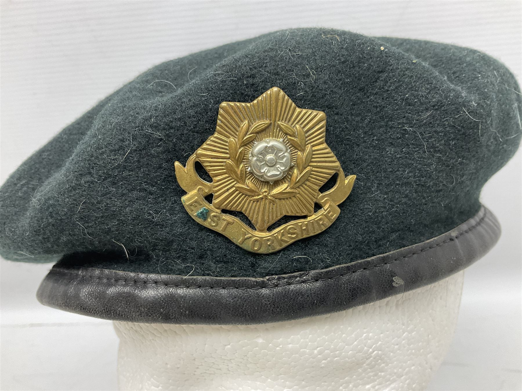 WW1 British Army Derby Scheme 1915 Attested armband; beret with East Yorkshire cap badge; pair of fur lined leather flying/motorcycle goggles; HMS Pembroke cap band; and small quantity of RNAS cloth and metal badges etc
