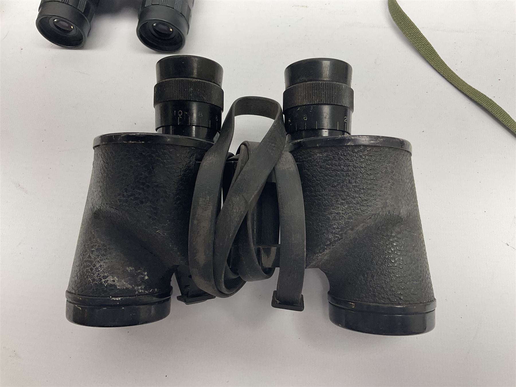 Pair of British World War Two issue black-painted binoculars, Bino 7x50 No. 5, 6E/320, No. 87412, MoD.B/42, with case, together with Nipole 10 x 50 binoculars and two other pairs