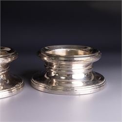 Pair of modern silver mounted candle holders, of circular stepped form, hallmarked Broadway & Co, Birmingham 2006, H5.5cm, D11cm