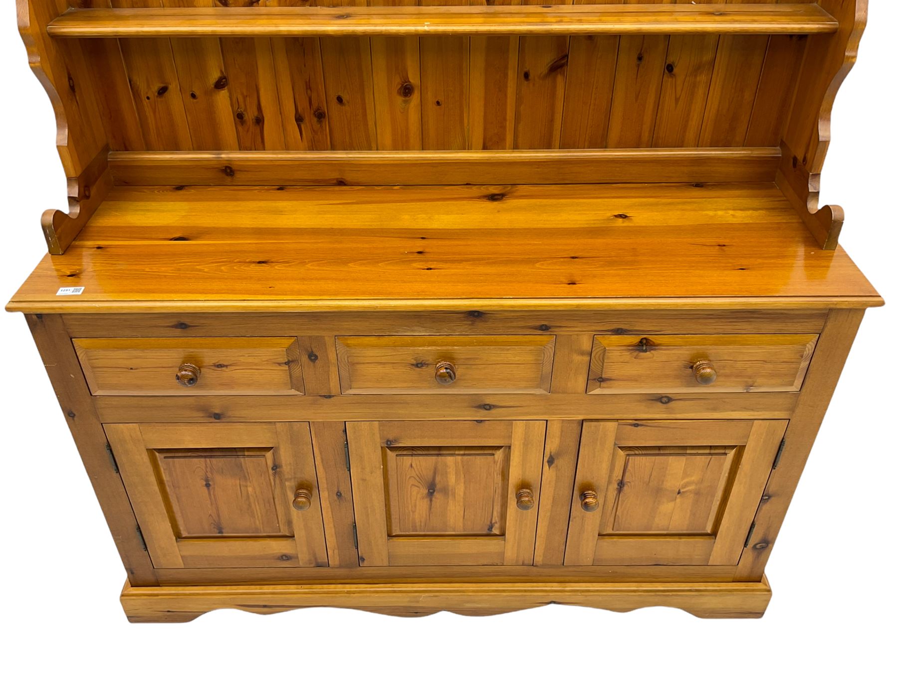 Pine farmhouse dresser with three drawers and three cupboards, and two tier plate rack
