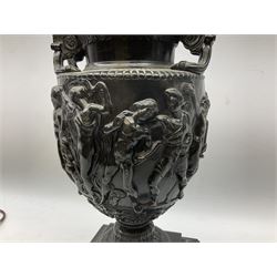 Neo classical style black painted twin handled lamp, decorated with classical scenes, with pedestal base raised upon shaped stepped square plinth, H62cm overall