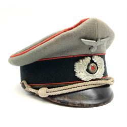 WW2 German Army Artillery officer's peaked cap, red piping to the crown and bordering the central band, zinc eagle and aluminium cockade insignia, officer's bullion chin cords, interior retains original sweatband and lining has tailor's celluloid diamond with 'Extra Klasse' logo and 'Marke Standard'